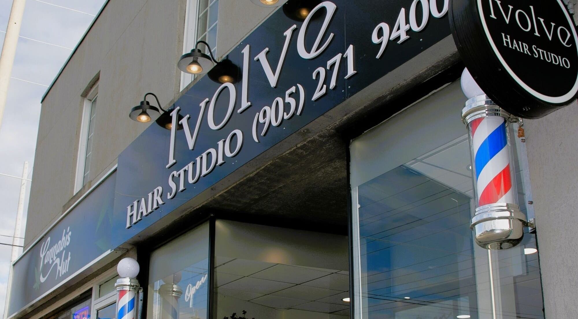 Ivolve Hair Studio entrance in Mississauga, Ontario with vibrant signage and barber pole.