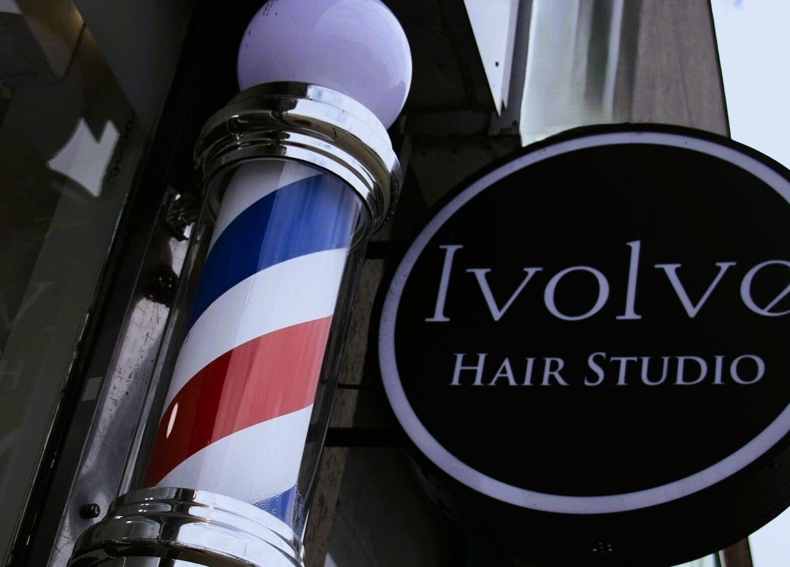 Ivolve Hair Studio sign and barber pole in Mississauga, Ontario, CA.