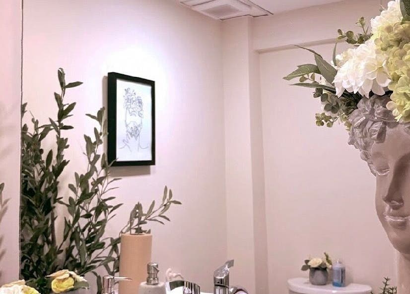 Elegant decor at Ivolve Hair Studio, Mississauga, Ontario, CA featuring greenery and floral accents.