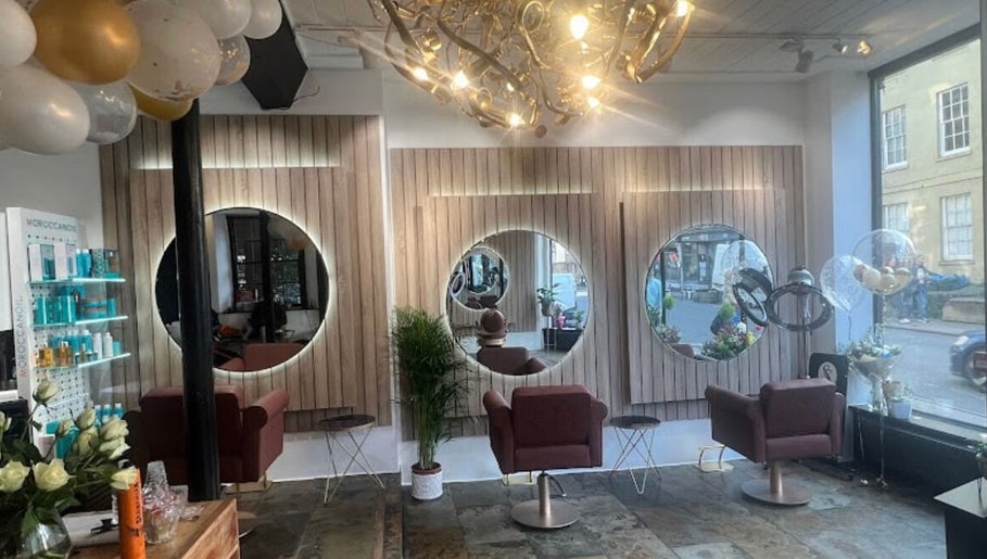 Chic salon interior at Saria Styles in Bristol, England, GB, featuring elegant mirrors and stylish seating.