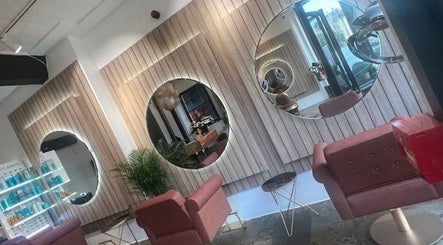Modern salon interior at Saria Styles in Bristol, England, GB featuring elegant mirrors and plush seating.