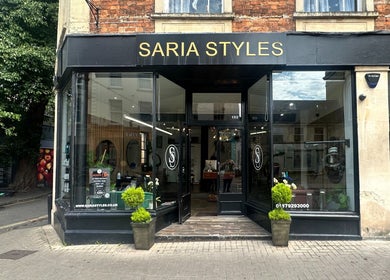 Saria Styles salon entrance in Bristol, England, GB, featuring elegant signage and sleek modern decor.