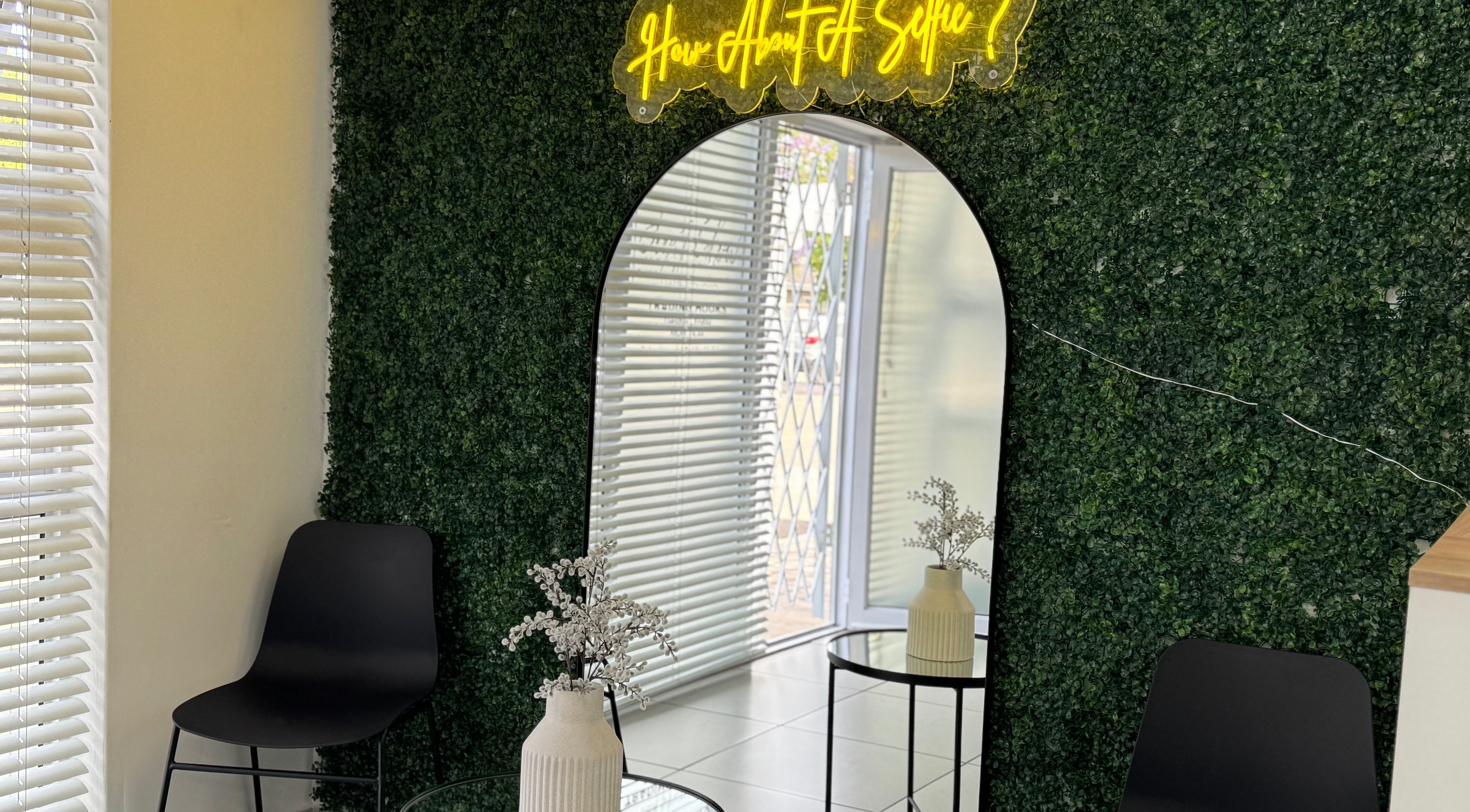 Stylish selfie corner at Just Glow Hair Studio, Cape Town, Western Cape, ZA, with modern decor and seating.