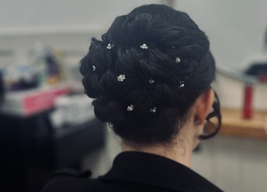 Intricate bridal updo with floral pins at Styled By Tee Swales, Hartlepool, England, GB.
