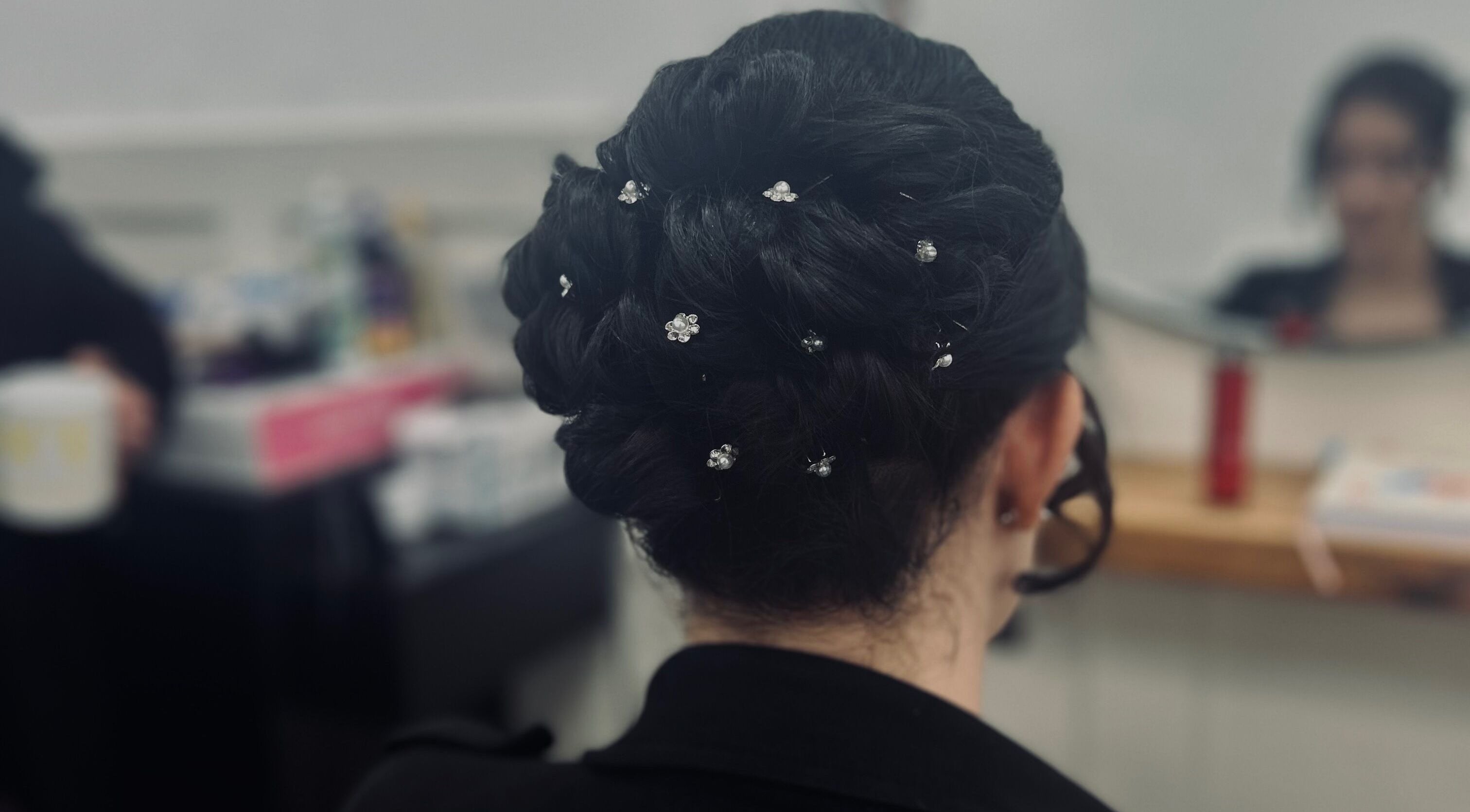 Intricate bridal updo with floral pins at Styled By Tee Swales, Hartlepool, England, GB.
