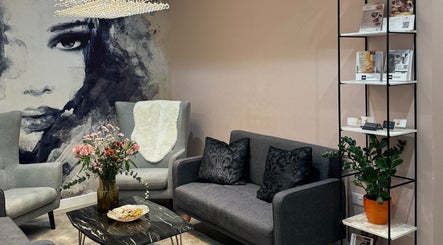 Modern lounge area at HAIRCULT, London, England, GB featuring chic decor and artistic wall art.