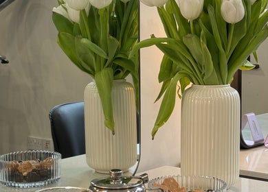 White tulips in a vase on HAIRCULT's stylish table in London, England, GB.