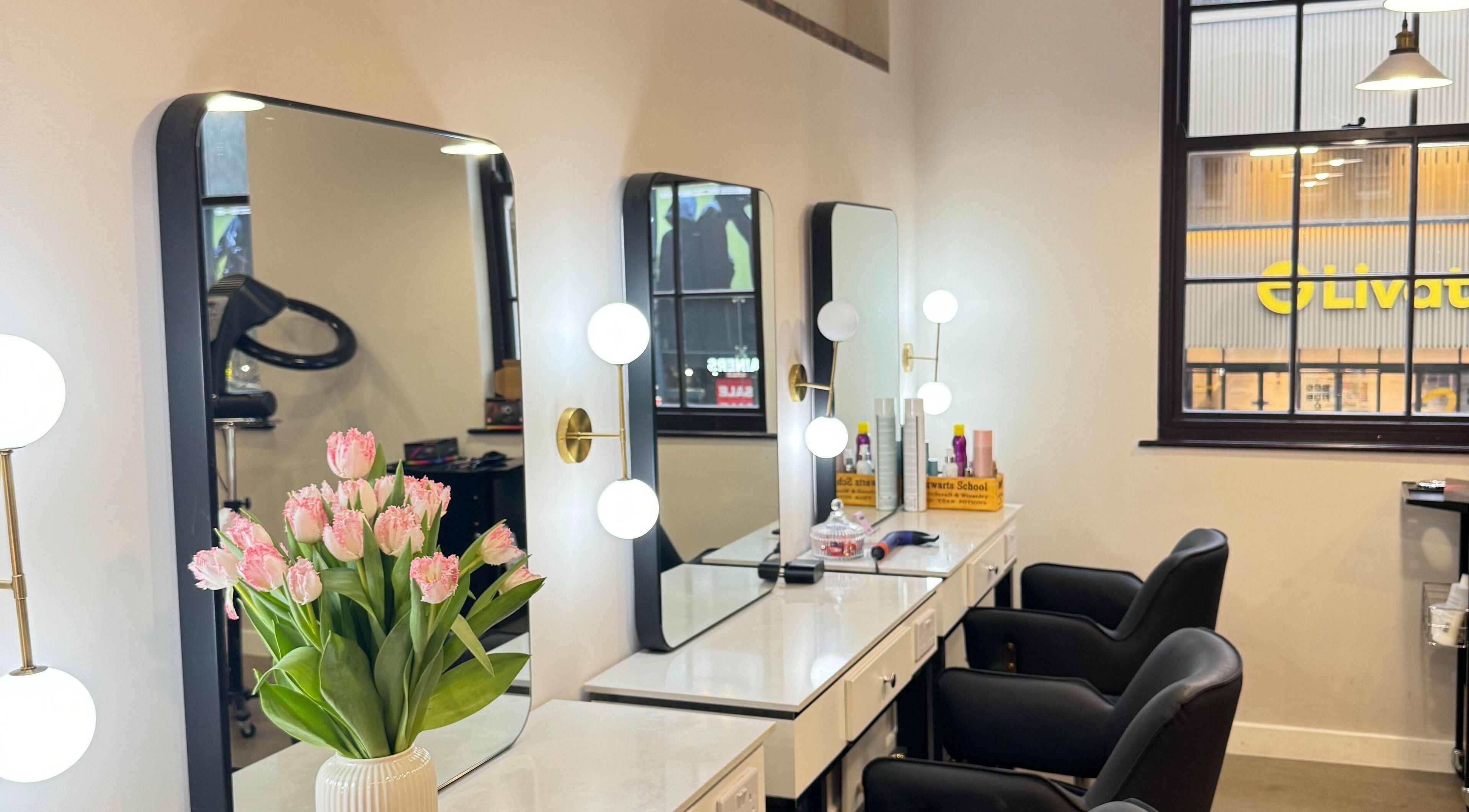 Elegant styling station at HAIRCULT in London, England, GB featuring sleek mirrors and tulip decor.