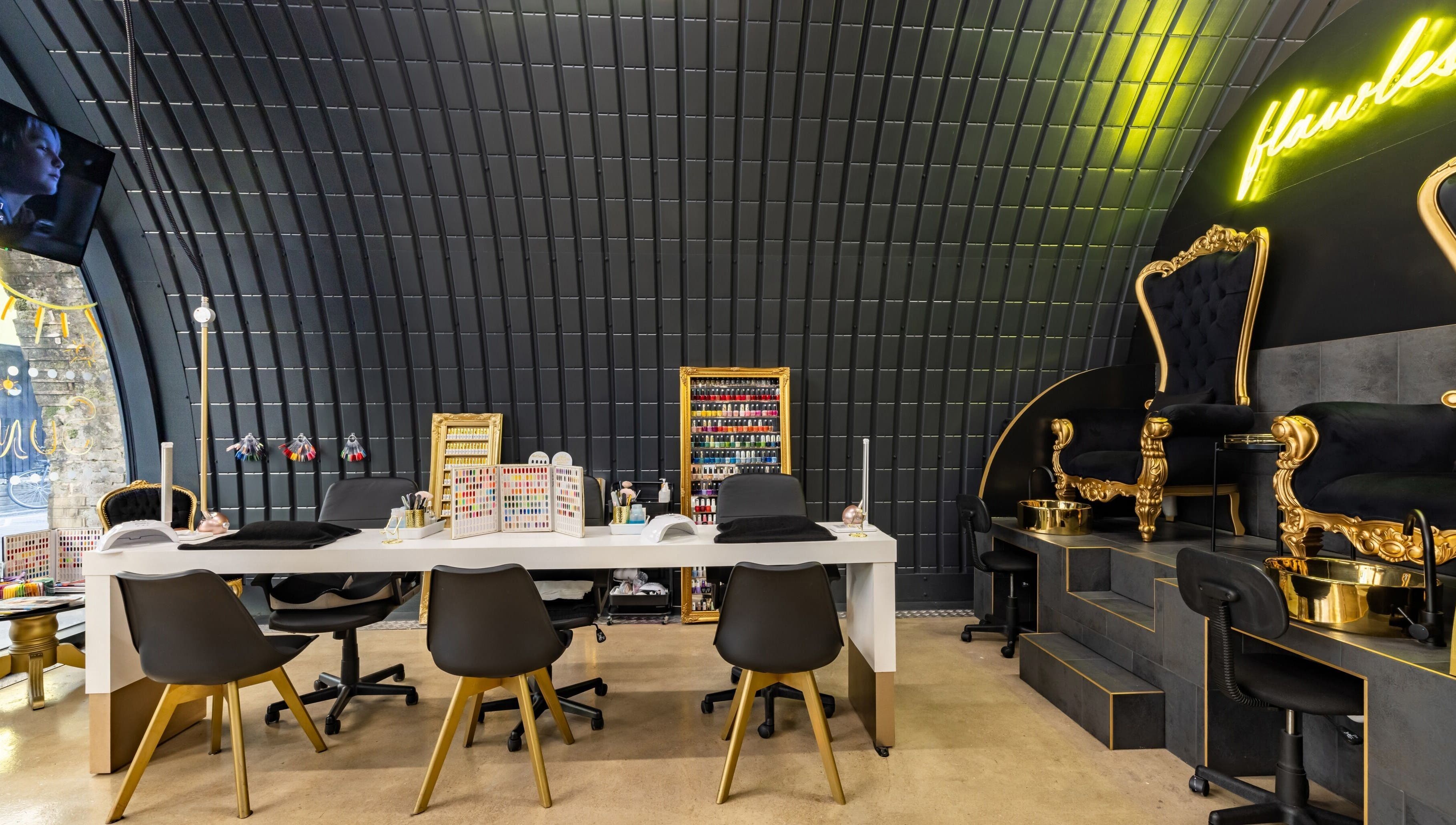 Elegant nail salon interior at Dima Beautiful, London, England, GB, showcasing luxury seating and chic decor.