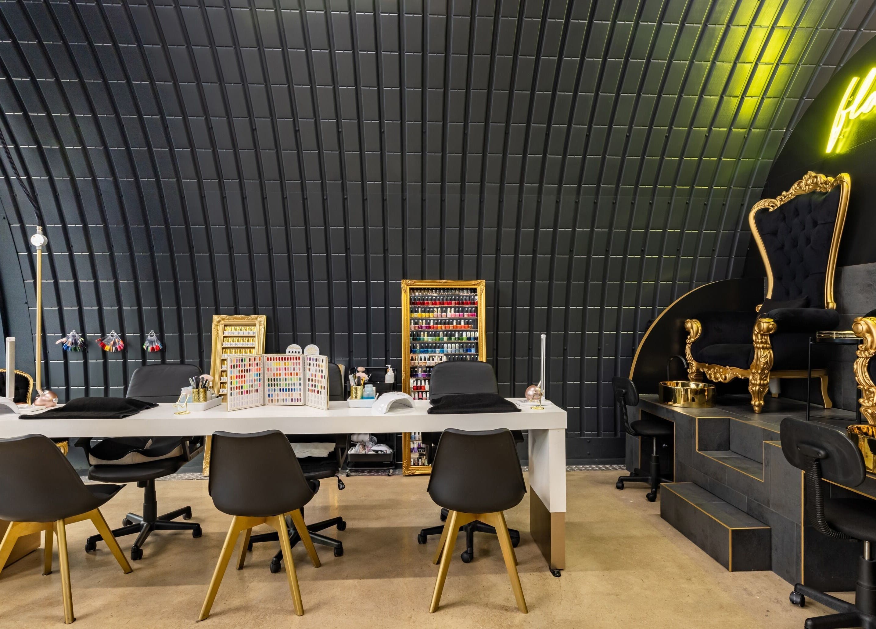 Elegant nail salon interior at Dima Beautiful, London, England, GB, showcasing luxury seating and chic decor.