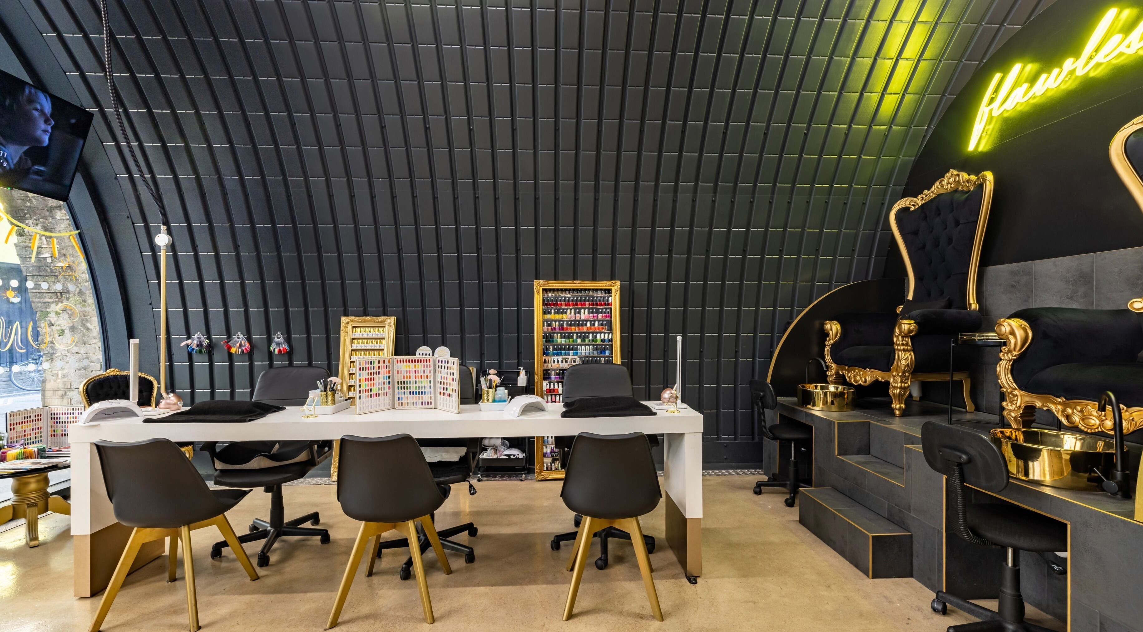 Elegant nail salon interior at Dima Beautiful, London, England, GB, showcasing luxury seating and chic decor.