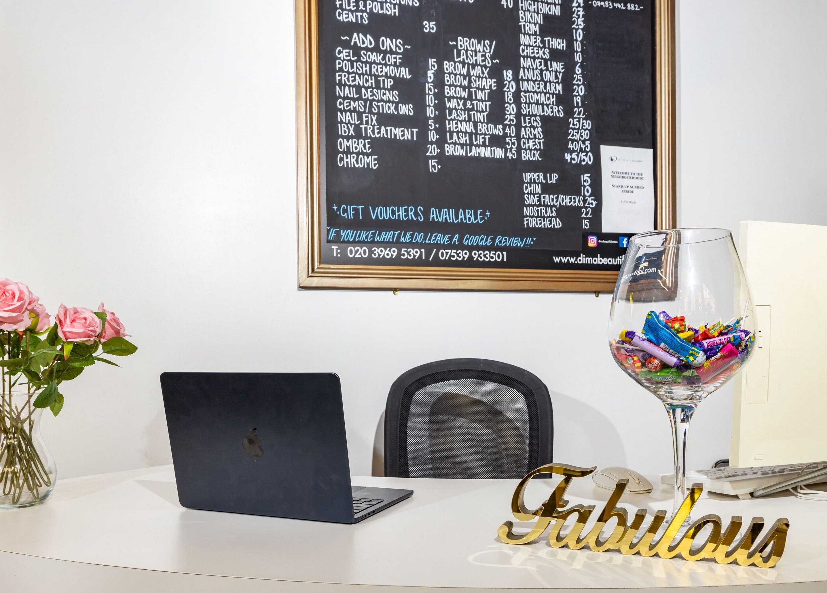 Reception at Dima Beautiful in London, England, GB featuring elegant decor and service menu on display.