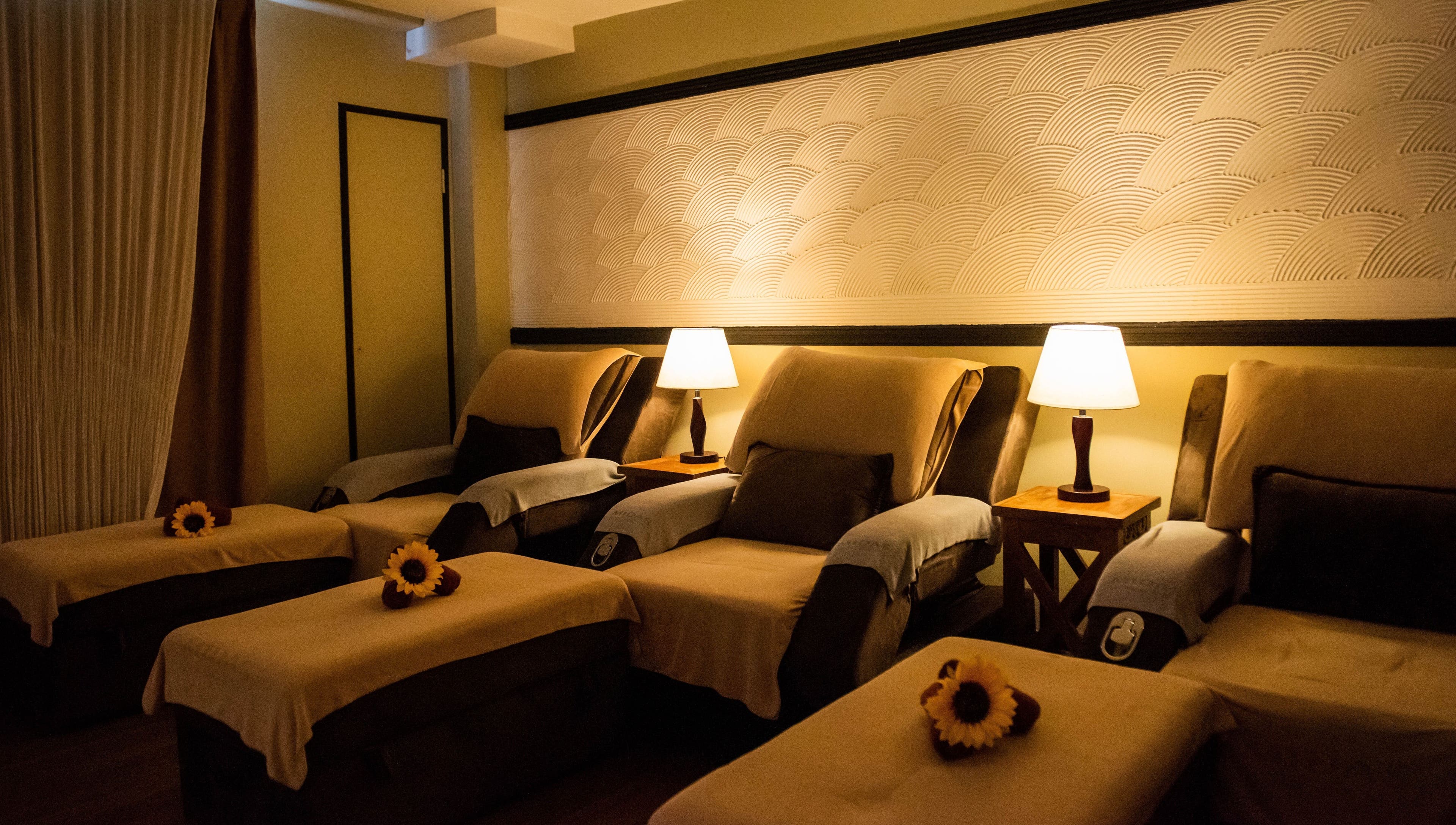 Cozy lounge chairs at Midas Wellness & Spa, Kota Kinabalu, Sabah, MY with soft lighting and elegant decor.
