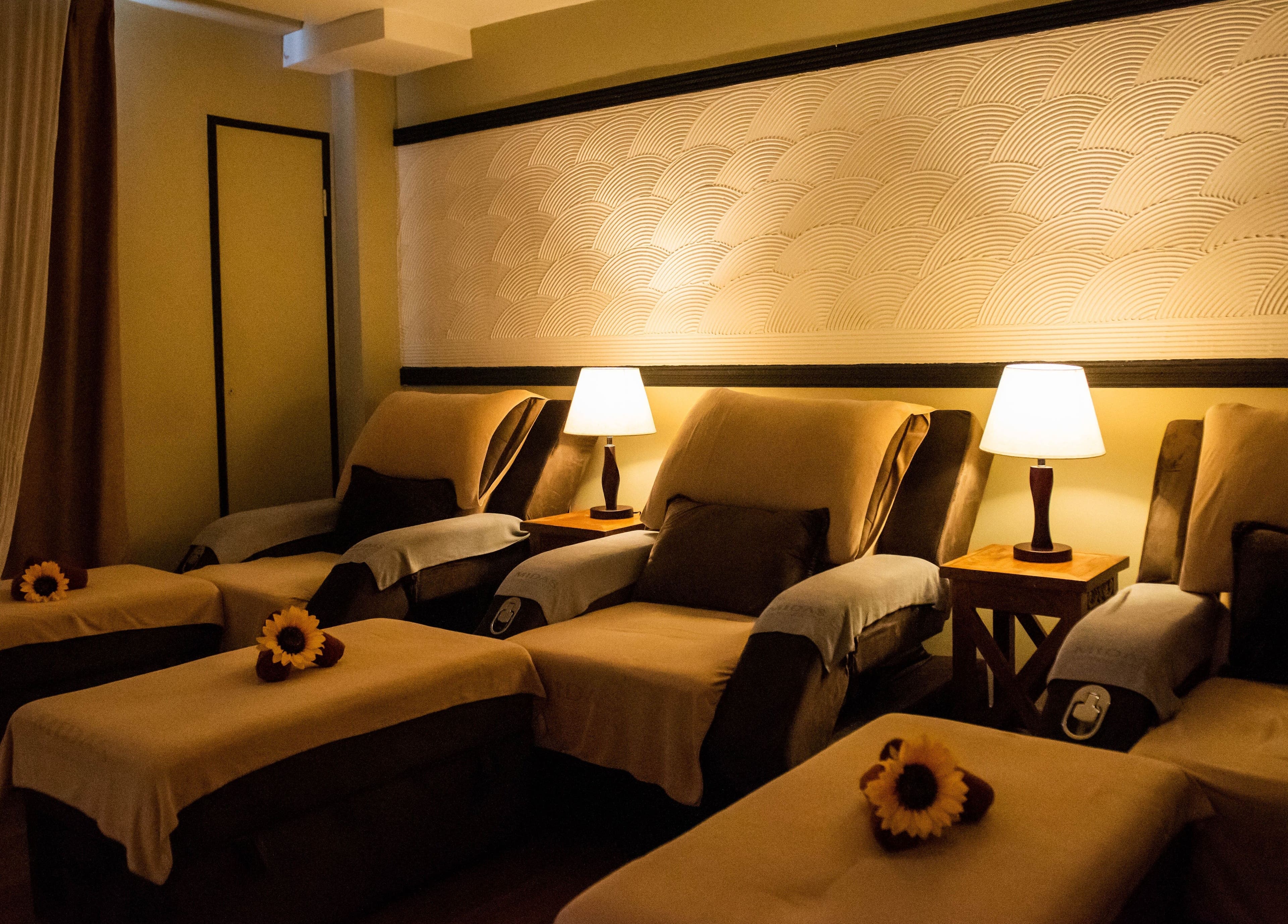 Cozy lounge chairs at Midas Wellness & Spa, Kota Kinabalu, Sabah, MY with soft lighting and elegant decor.