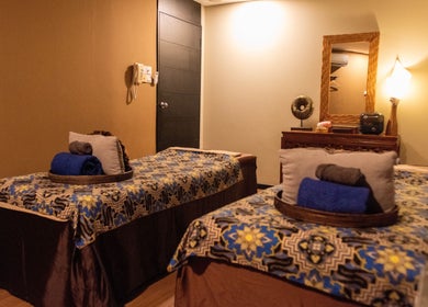Relaxing massage room at Midas Wellness & Spa, Kota Kinabalu, Sabah, MY, featuring double beds and soft lighting.