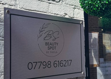 Metal sign of Beauty Spot By Paula at Bridgnorth, England, GB with contact details and greenery decor.