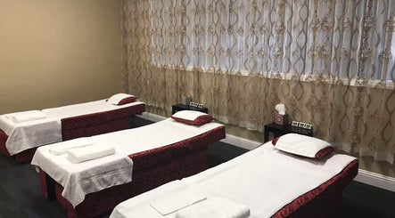 Three massage beds in a tranquil room at Warm Foot Spa, Atascadero, California, US.