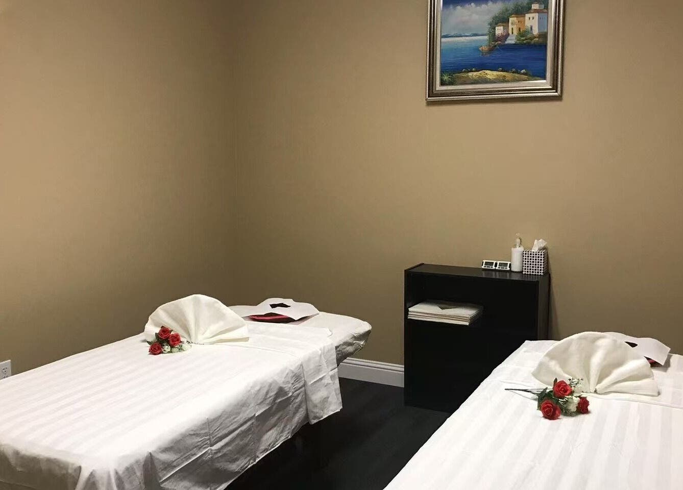 Relaxing massage room at Warm Foot Spa, Atascadero, California, US, featuring two neatly arranged treatment beds.