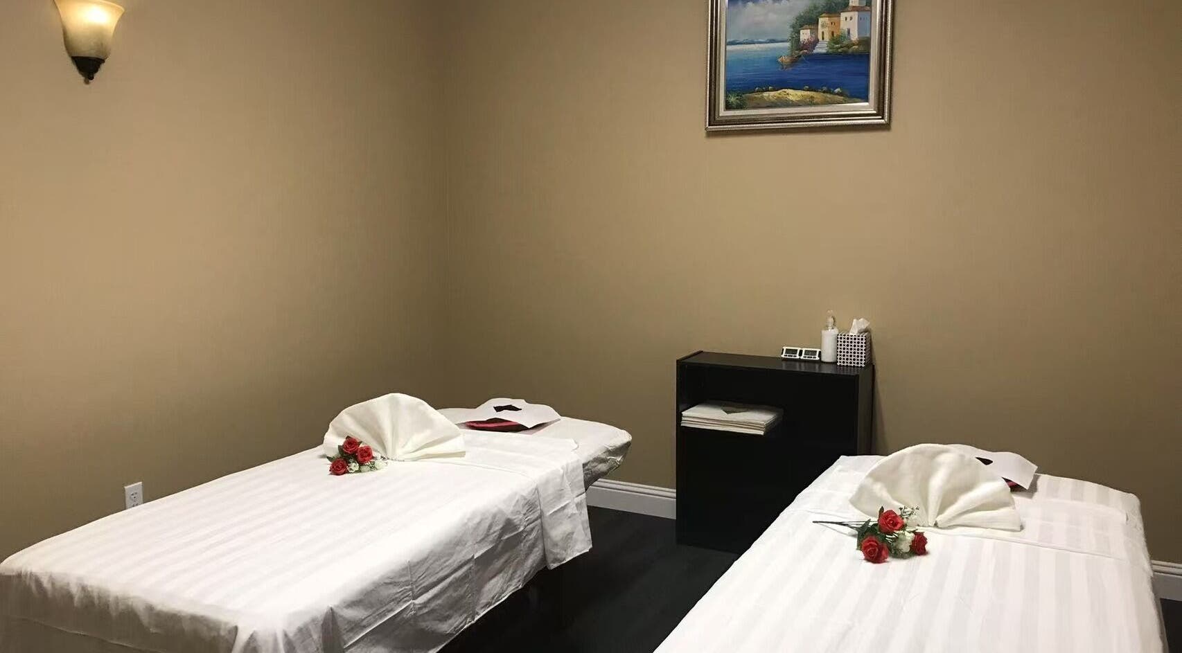 Relaxing massage room at Warm Foot Spa, Atascadero, California, US, featuring two neatly arranged treatment beds.