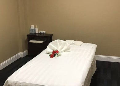 Elegant massage room at Warm Foot Spa, Atascadero, California, US, featuring a serene setup with red roses.