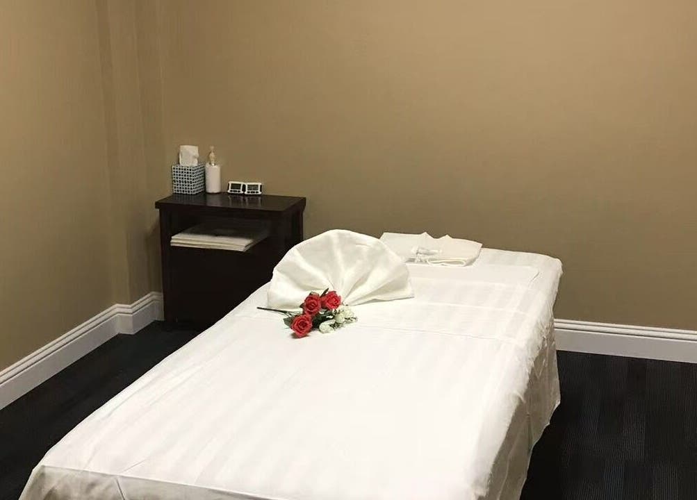 Elegant massage room at Warm Foot Spa, Atascadero, California, US, featuring a serene setup with red roses.