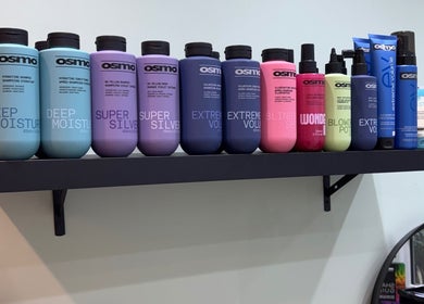 Assorted hair products on a shelf at Secret Sanctuary, Park Gate, England, GB for vibrant styling needs.