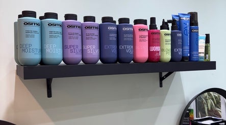 Assorted hair products on a shelf at Secret Sanctuary, Park Gate, England, GB for vibrant styling needs.