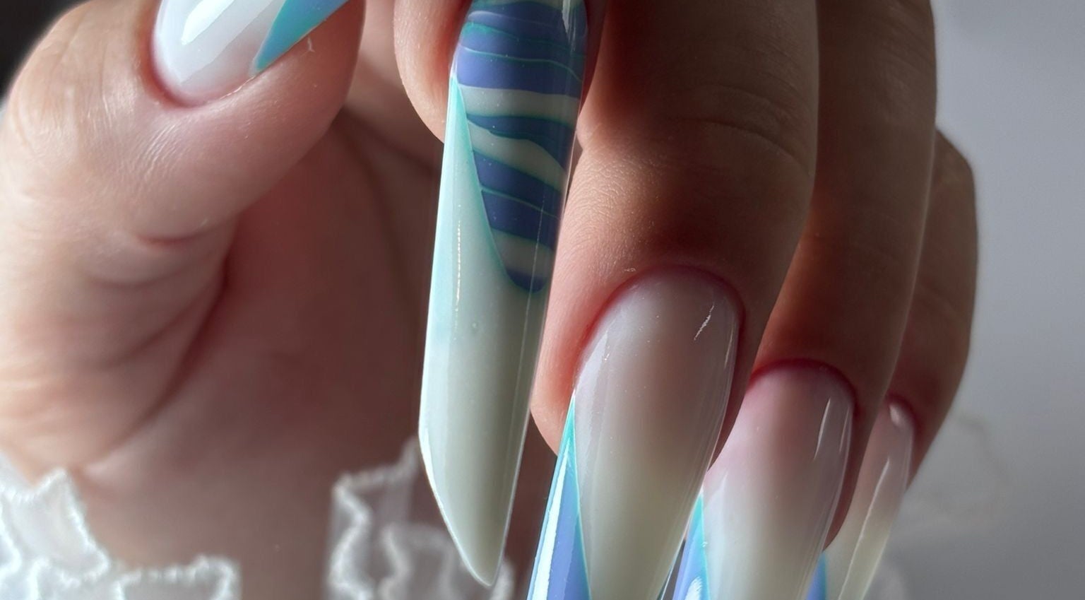 Stunning nail art with blue accents at Giulia Nails Atelier, Norwich, England, GB.