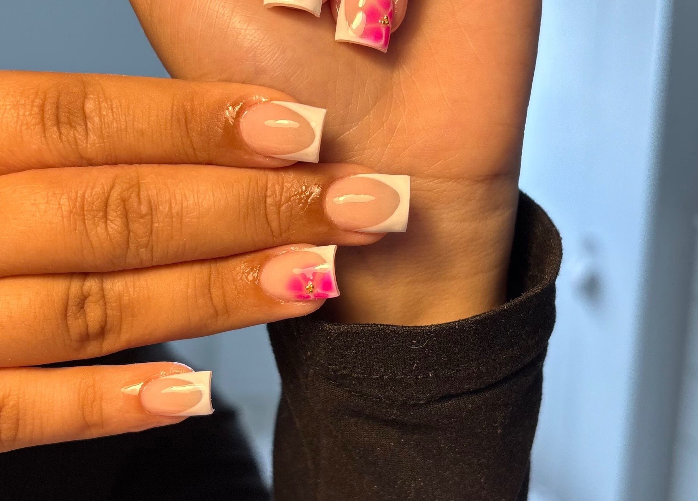 Elegant French manicure with pink floral design at xx.madebybia, Peterborough, England, GB.