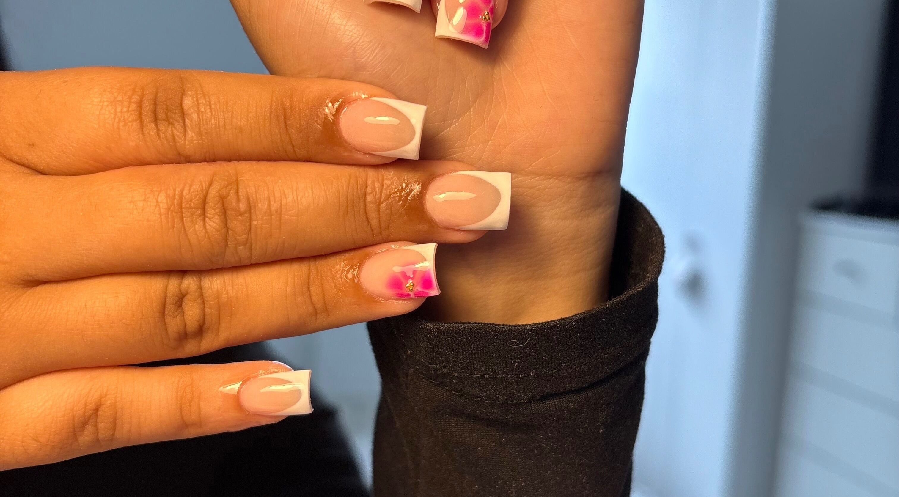 Elegant French manicure with pink floral design at xx.madebybia, Peterborough, England, GB.