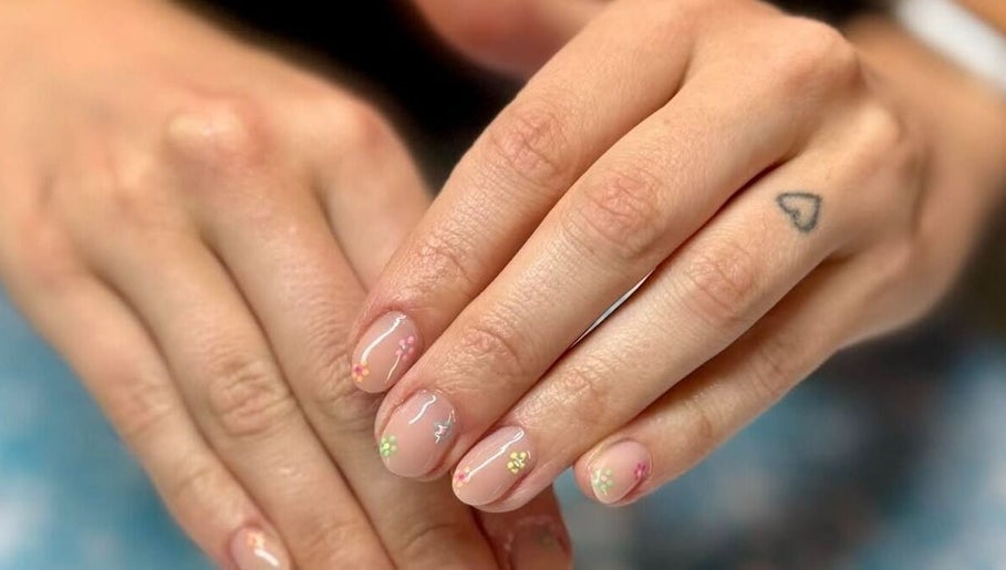 Close-up of hands with floral nail art at Skyhawk Beauty, Christchurch, Canterbury, NZ.