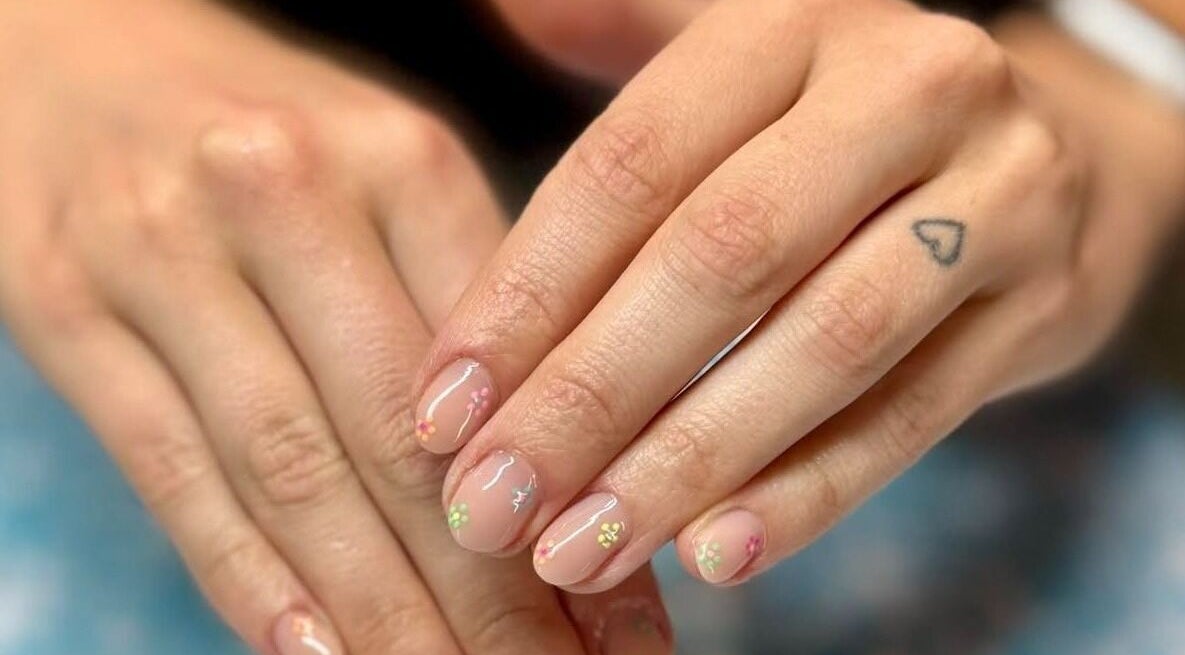 Close-up of hands with floral nail art at Skyhawk Beauty, Christchurch, Canterbury, NZ.
