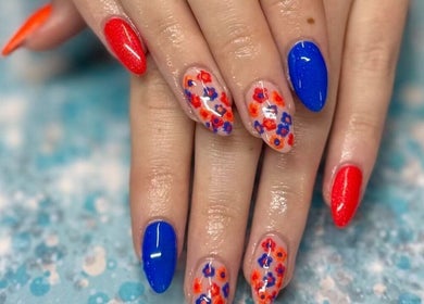 Colorful nail art showcasing red and blue designs at Skyhawk Beauty, Christchurch, Canterbury, NZ.