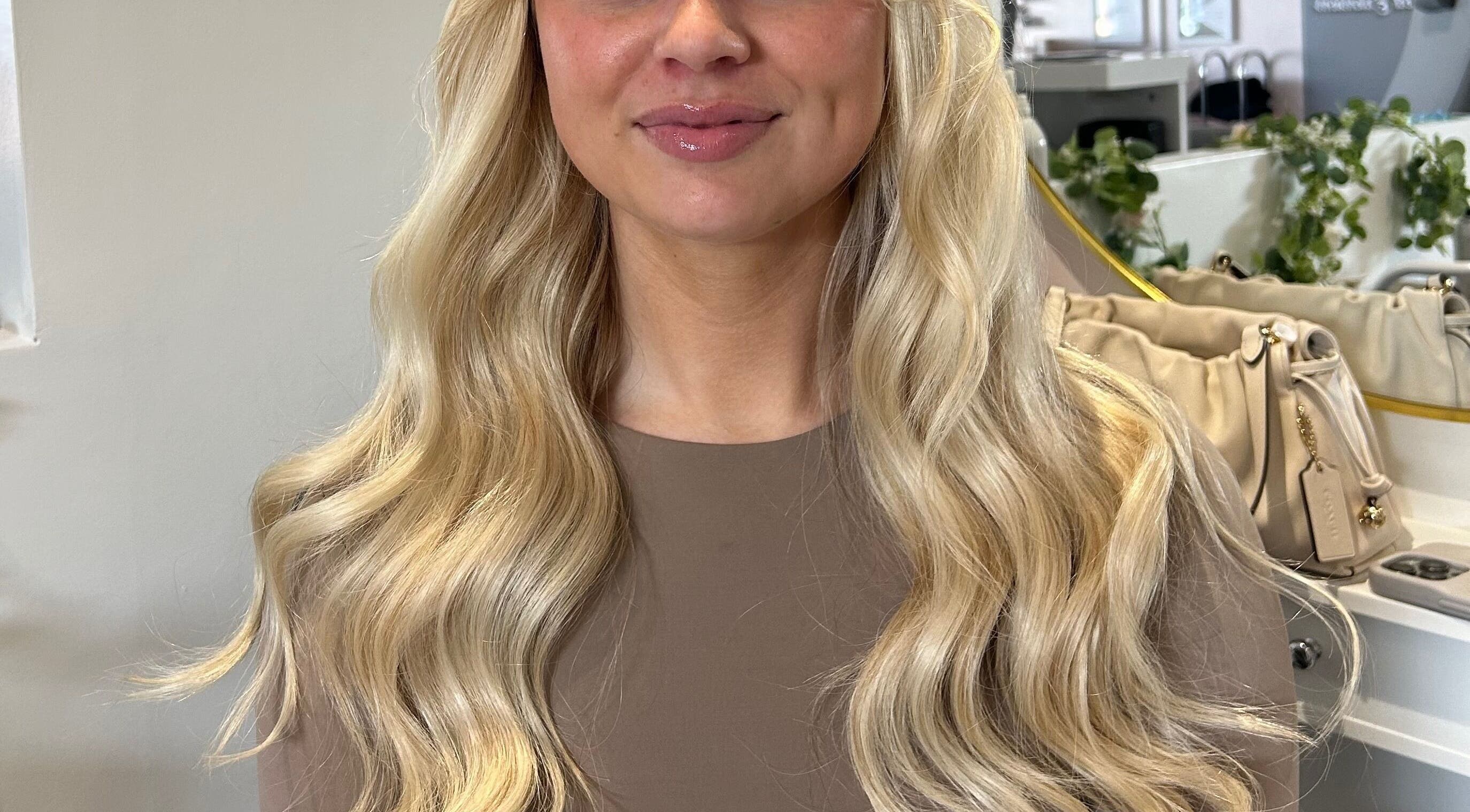 Long, blonde wavy hair at AIM Hair Extensions in Kessingland, England, GB, enhancing natural beauty.