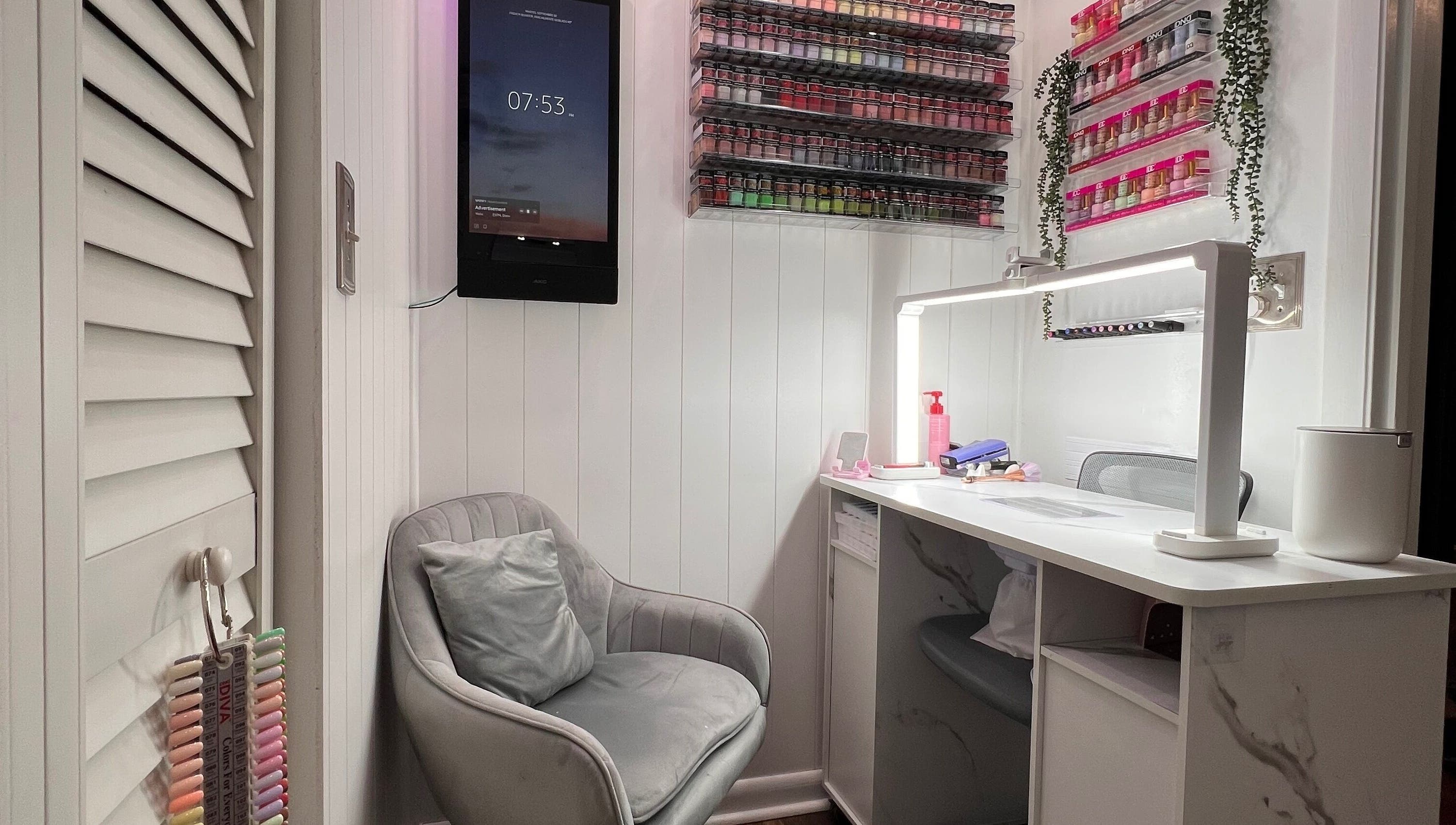 Cozy nail beauty corner at Carolinailedit, Wellington, Florida, US, with a modern chair and organized supplies.