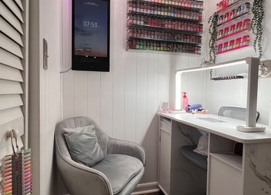 Cozy nail beauty corner at Carolinailedit, Wellington, Florida, US, with a modern chair and organized supplies.