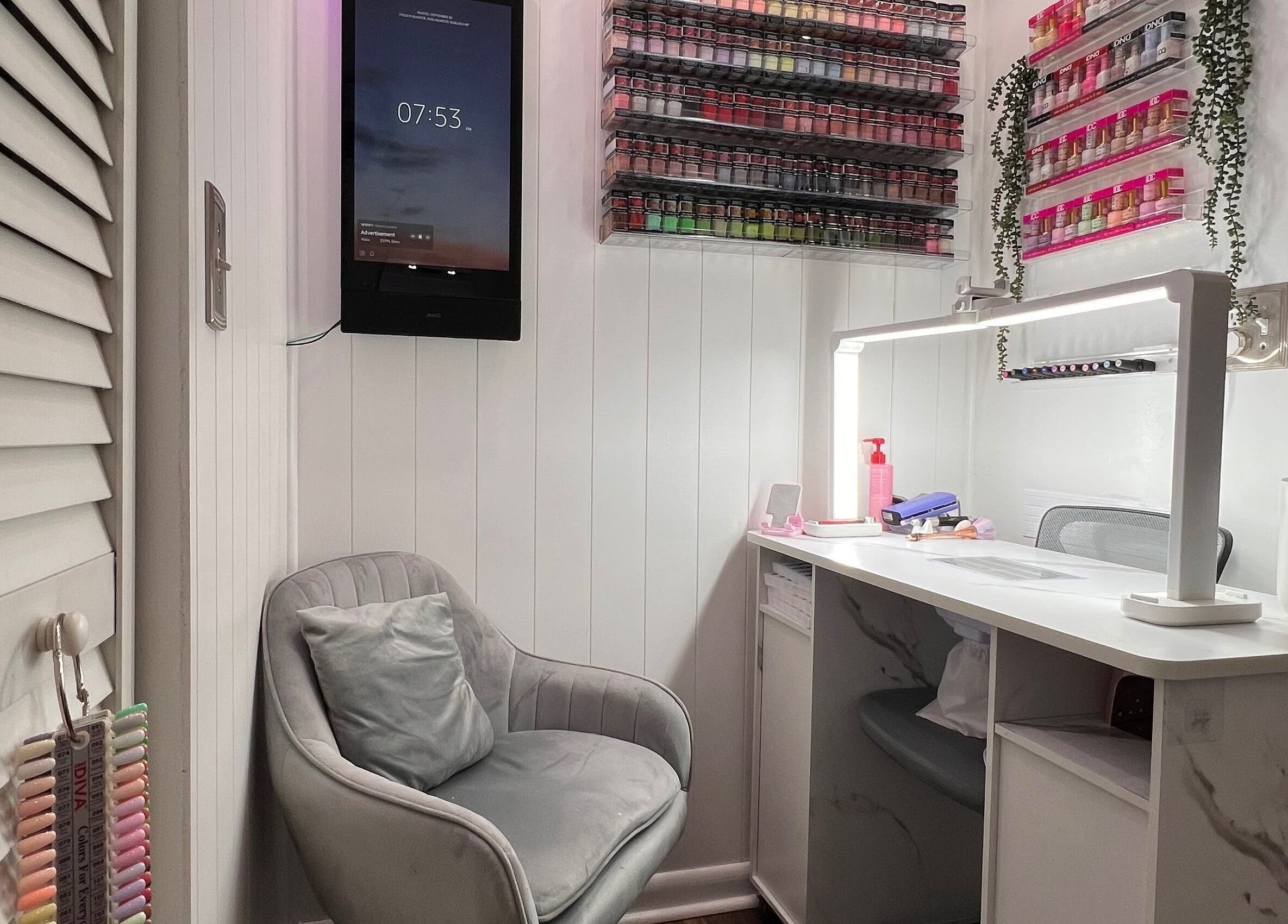 Cozy nail beauty corner at Carolinailedit, Wellington, Florida, US, with a modern chair and organized supplies.