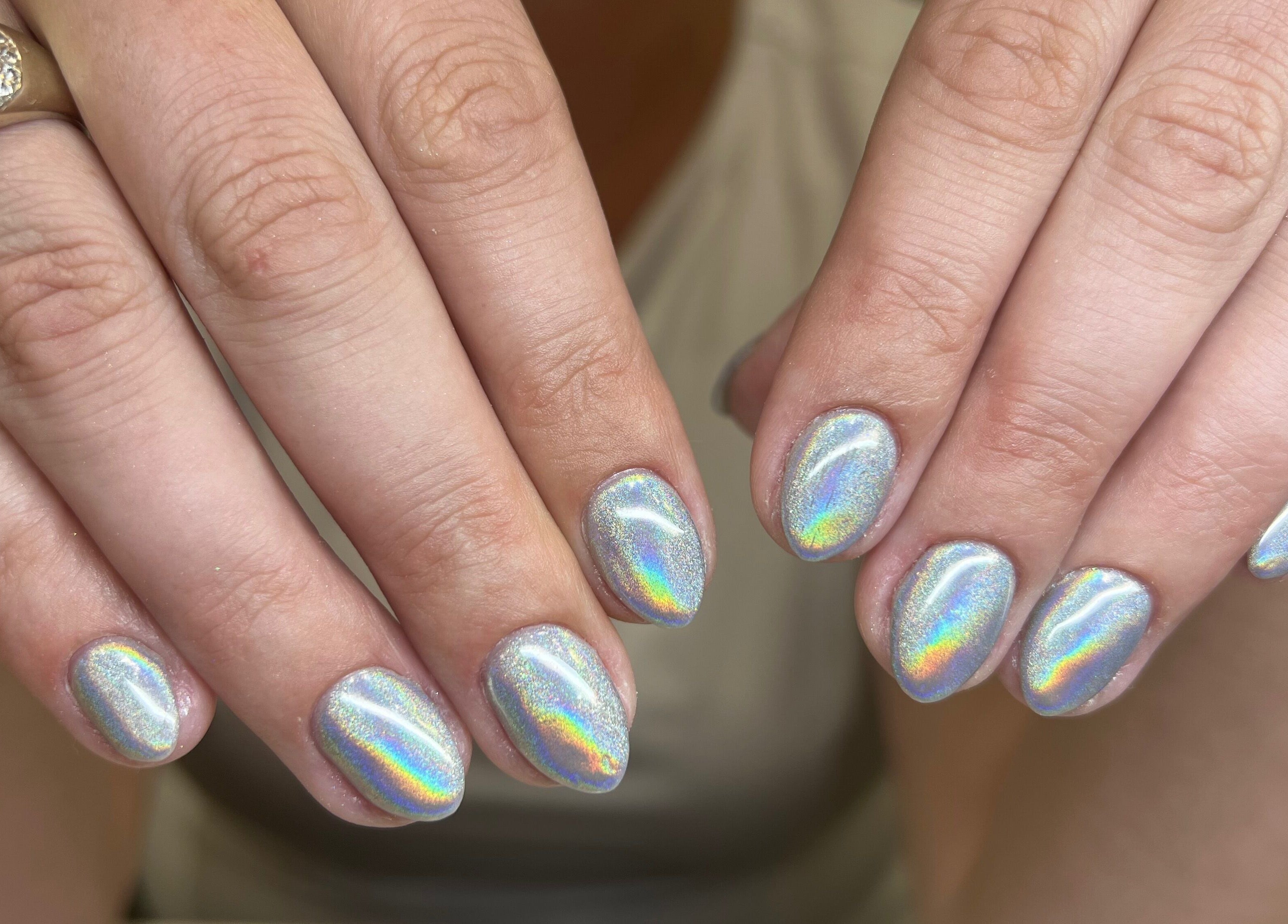 Holographic manicure at Carolinailedit in Wellington, Florida, US showcasing elegant nail designs.