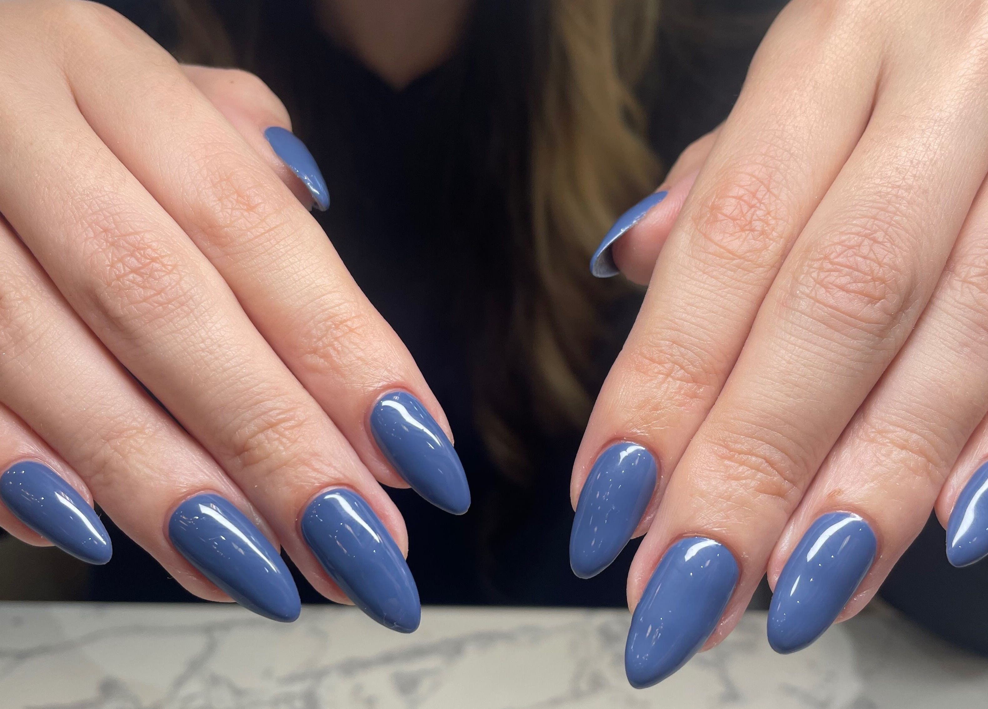 Elegant blue manicure at Carolinailedit, Wellington, Florida, US, showcasing glossy, well-groomed nails.
