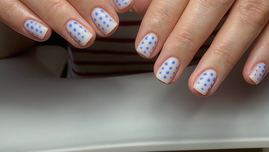 Blue polka dot nail art at The Elizabeth Nail Co. in Shoreham-by-sea, England, GB.