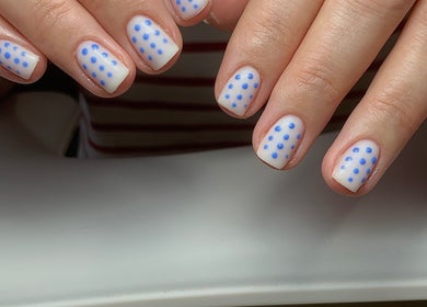 Blue polka dot nail art at The Elizabeth Nail Co. in Shoreham-by-sea, England, GB.