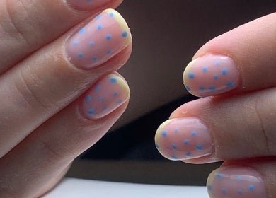 Close-up of pastel nails with blue polka dots at The Elizabeth Nail Co., Shoreham-by-sea, England, GB.