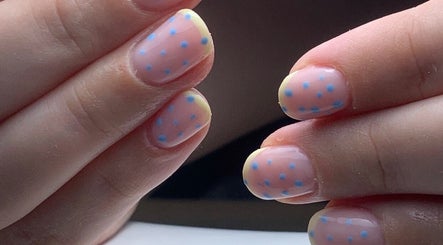 Close-up of pastel nails with blue polka dots at The Elizabeth Nail Co., Shoreham-by-sea, England, GB.