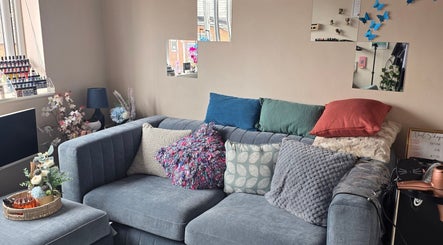Cozy seating area with decorative cushions at Sanctuary by Nymeria | Nymeria UK, Barnsley, England, GB.