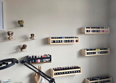 Nail polish shelves at Sanctuary by Nymeria | Nymeria UK, Barnsley, England, GB decorated with collectible figures.