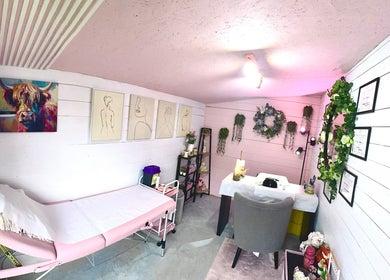 Cozy treatment room at Pixie Glow Aesthetics, Harlow, England, GB adorned with art and greenery.