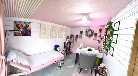 Cozy treatment room at Pixie Glow Aesthetics, Harlow, England, GB adorned with art and greenery.