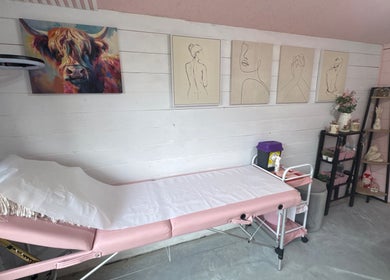 Modern treatment room at Pixie Glow Aesthetics, Harlow, England, featuring artistic wall decor and a cozy setup.