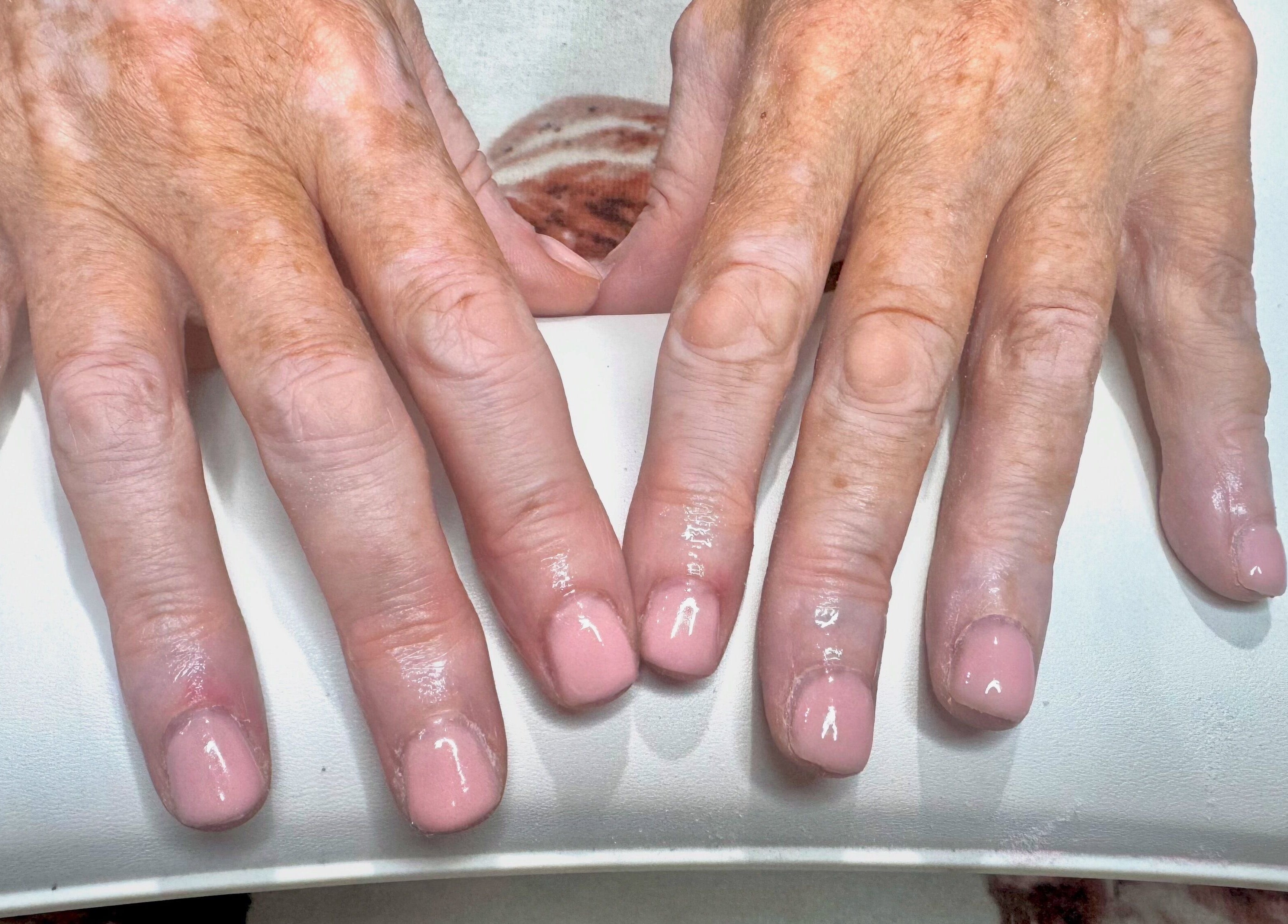 Freshly manicured nails at Pixie Glow Aesthetics & Nails in Harlow, England, GB showcasing a glossy finish.