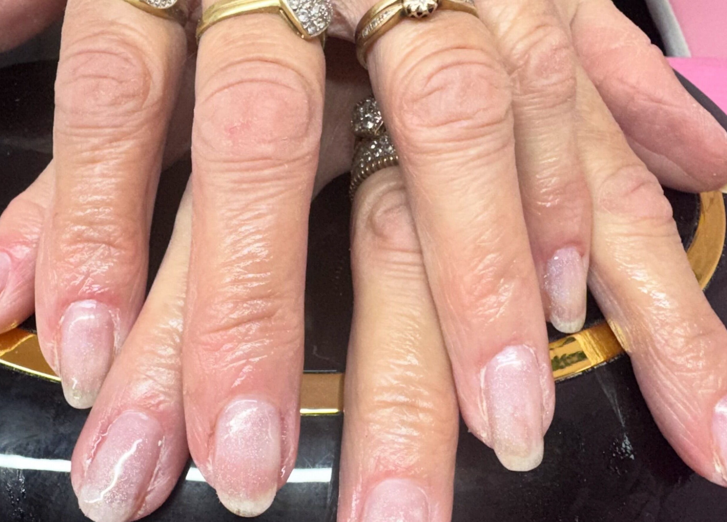 Close-up of manicured hands with rings at Pixie Glow Aesthetics & Nails, Harlow, England, GB.